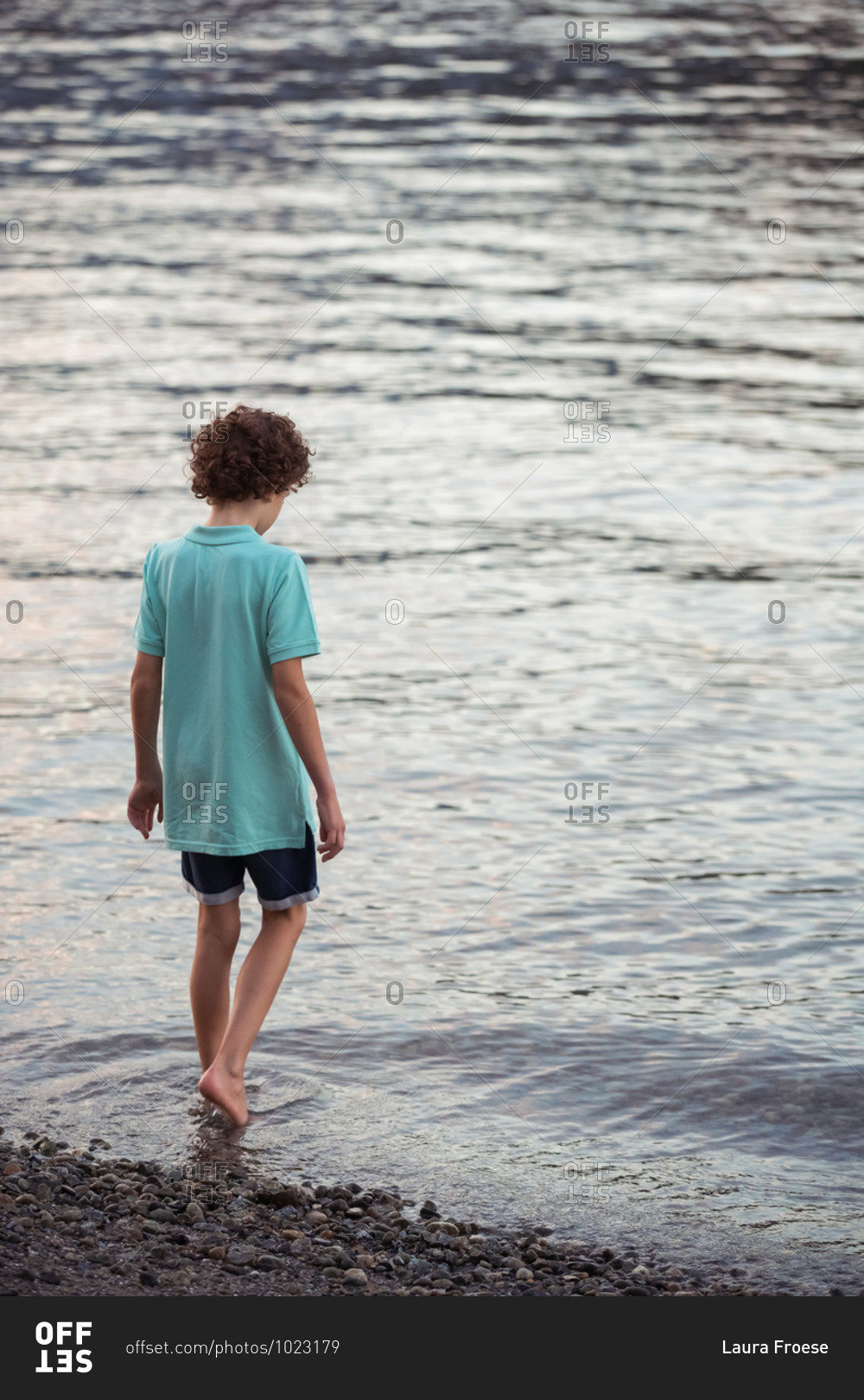 Boy wading in the waters at Barnet Marine Park in British Columbia, Canada