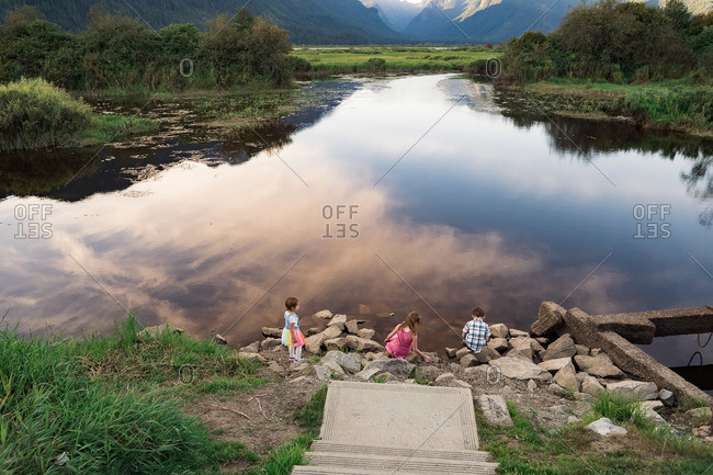 Three young children playing at Pitt Lake in British Columbia, Canada
