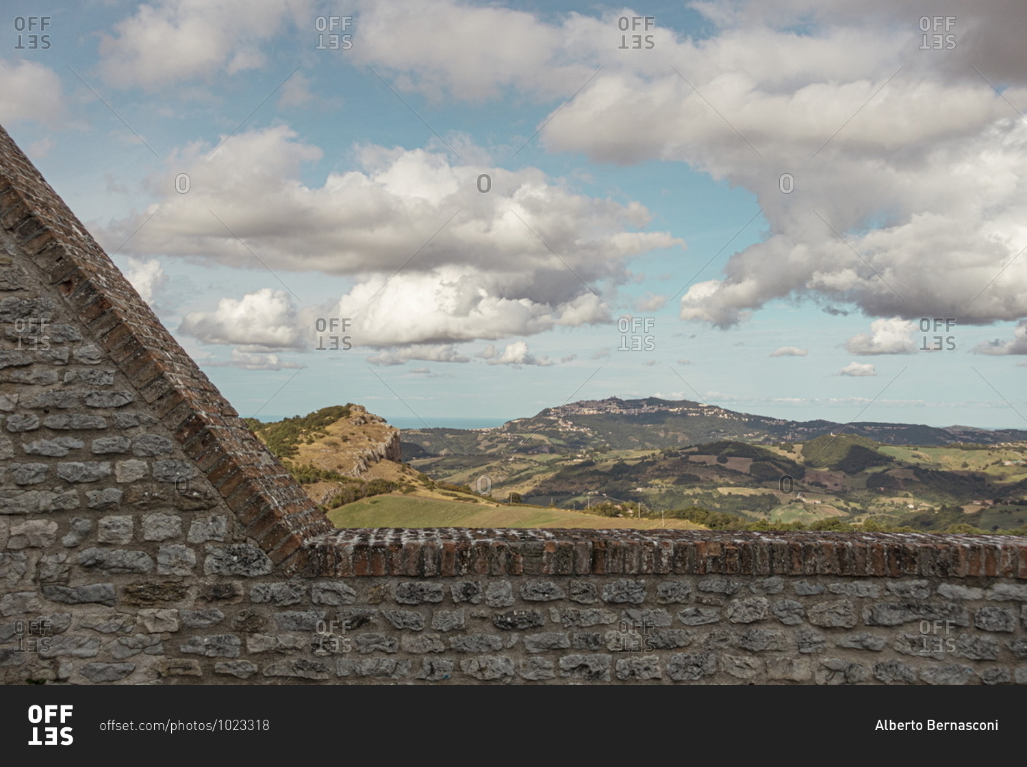 View of countryside over stone wall at the Fortress of San Leo, Marche, Italy