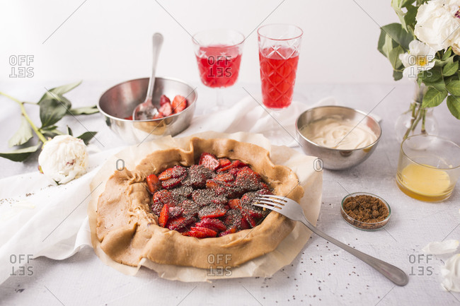A strawberry galette with vanilla bean and chia seeds being prepared