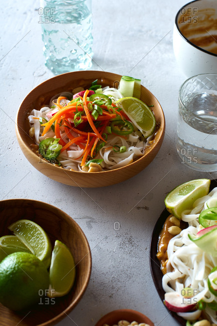 Vegan rice noodle salad made with fresh vegetables, lime and peanut sauce