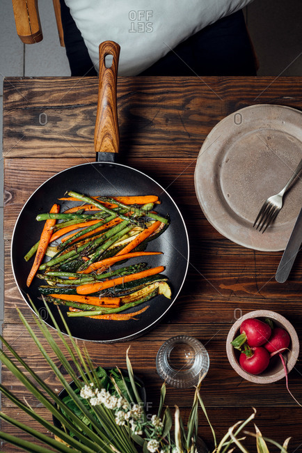 Carrot, asparagus and zucchini sauteed in the pan, on the table ready to eat. Simple and healthy vegan eating concept