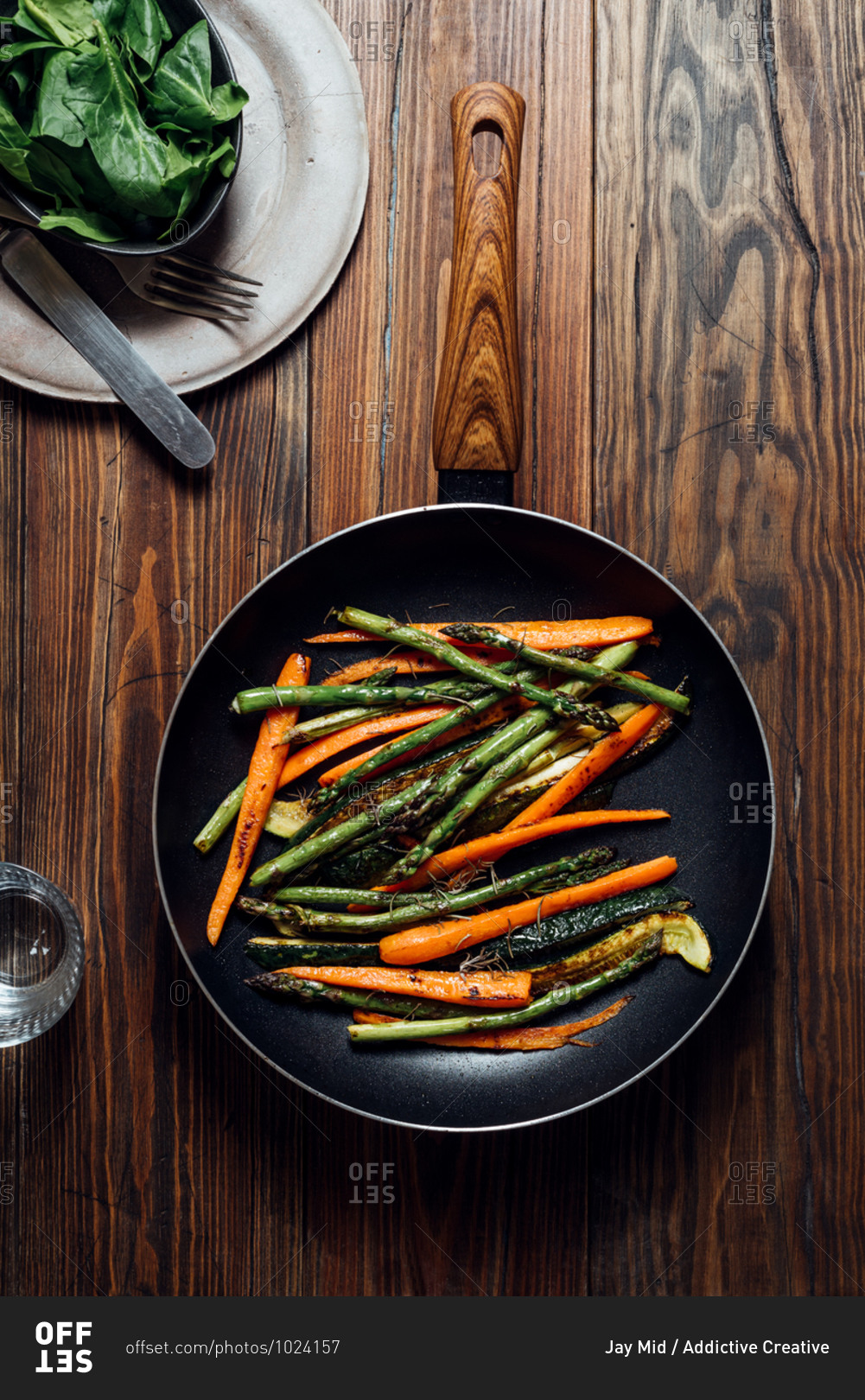 Carrot, asparagus and zucchini sauteed in the pan, on the table ready to eat. Simple and healthy vegan eating concept