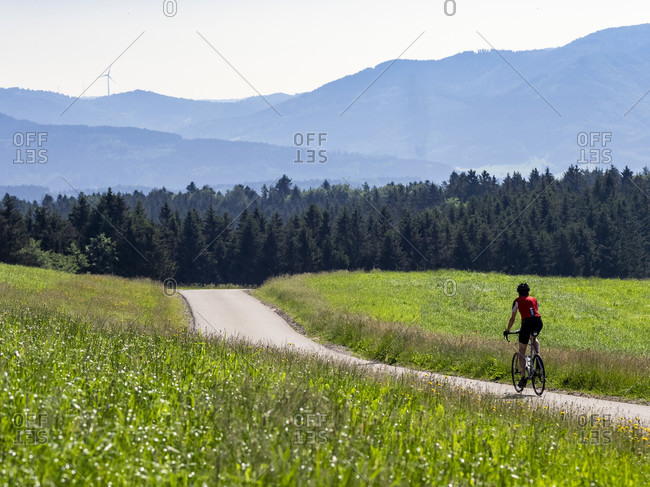 Road cyclist on a narrow mountain road in the Middle Black Forest, Biederbach municipality, Baden-Württemberg