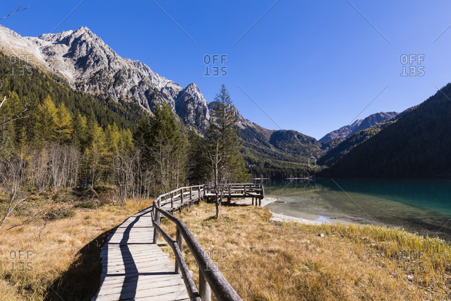 The new experience of nature path at Anterselva lake in autumn in front of the Mountains of the Nature Park Rieserferner-Ahrn, Valle di Anterselva, Pusteria Valley, Dolomites, Bolzano district, South Tyrol, TrentinoAlto Adige, Italy