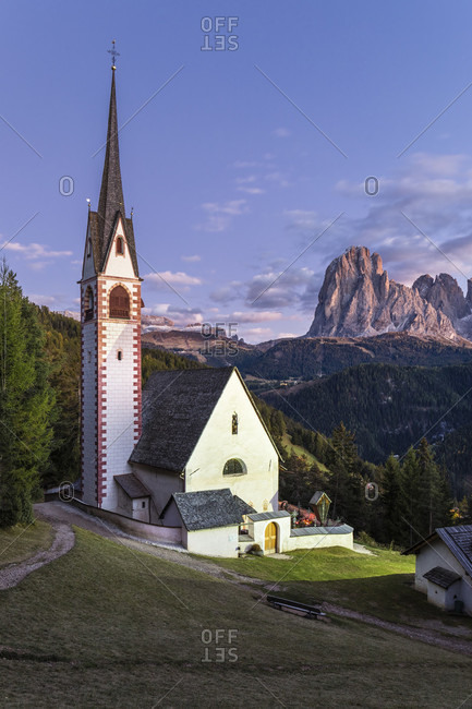 Illuminated St. Jakob church in front of Langkofel Group (3181m), St. Jakob, Groeden Valley, Dolomites, TrentinoAlto Adige, South Tyrol, Italy