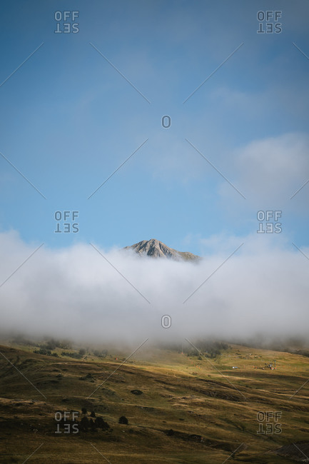 Mountain summit peeking above the clouds