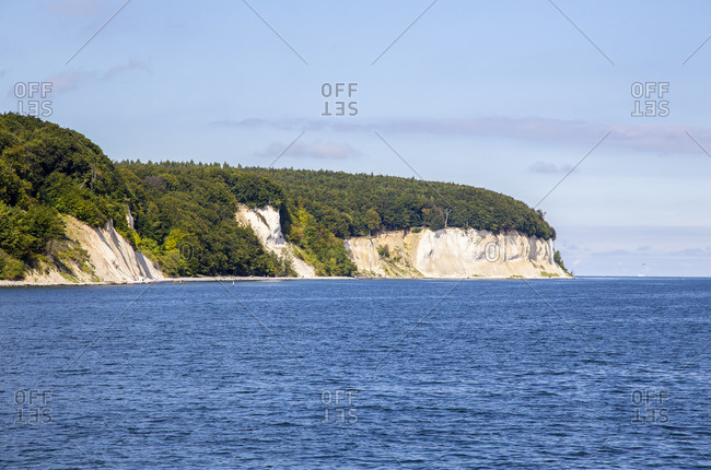 Scenic view of chalk cliffs of Ruegen island on sea against sky- Germany
