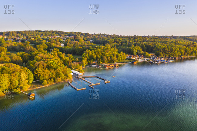 Germany- Bavaria- Feldafing- Drone view of marina on forested shore of Lake Starnberg in spring