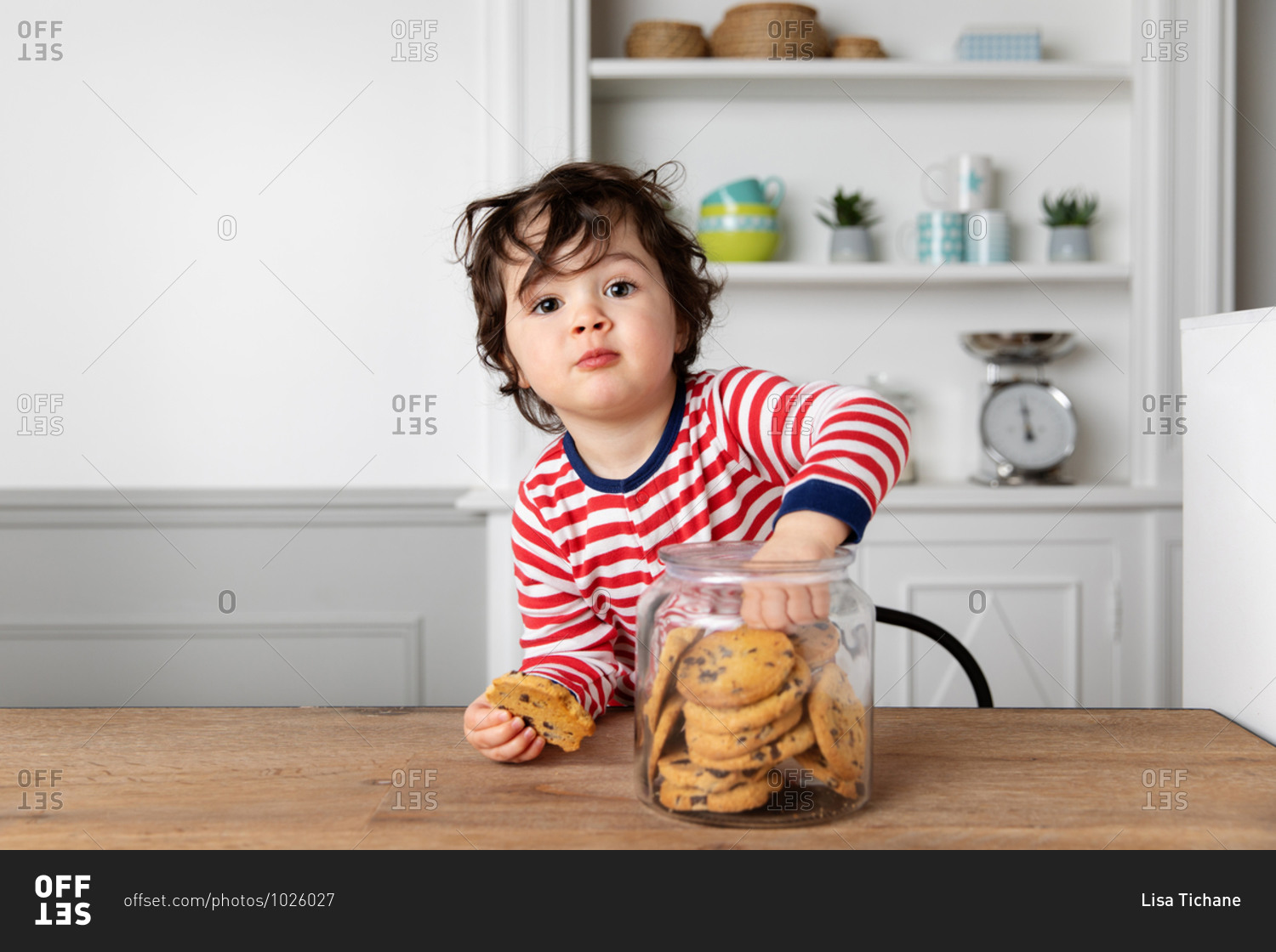 Cute toddler reaching into a cookie jar