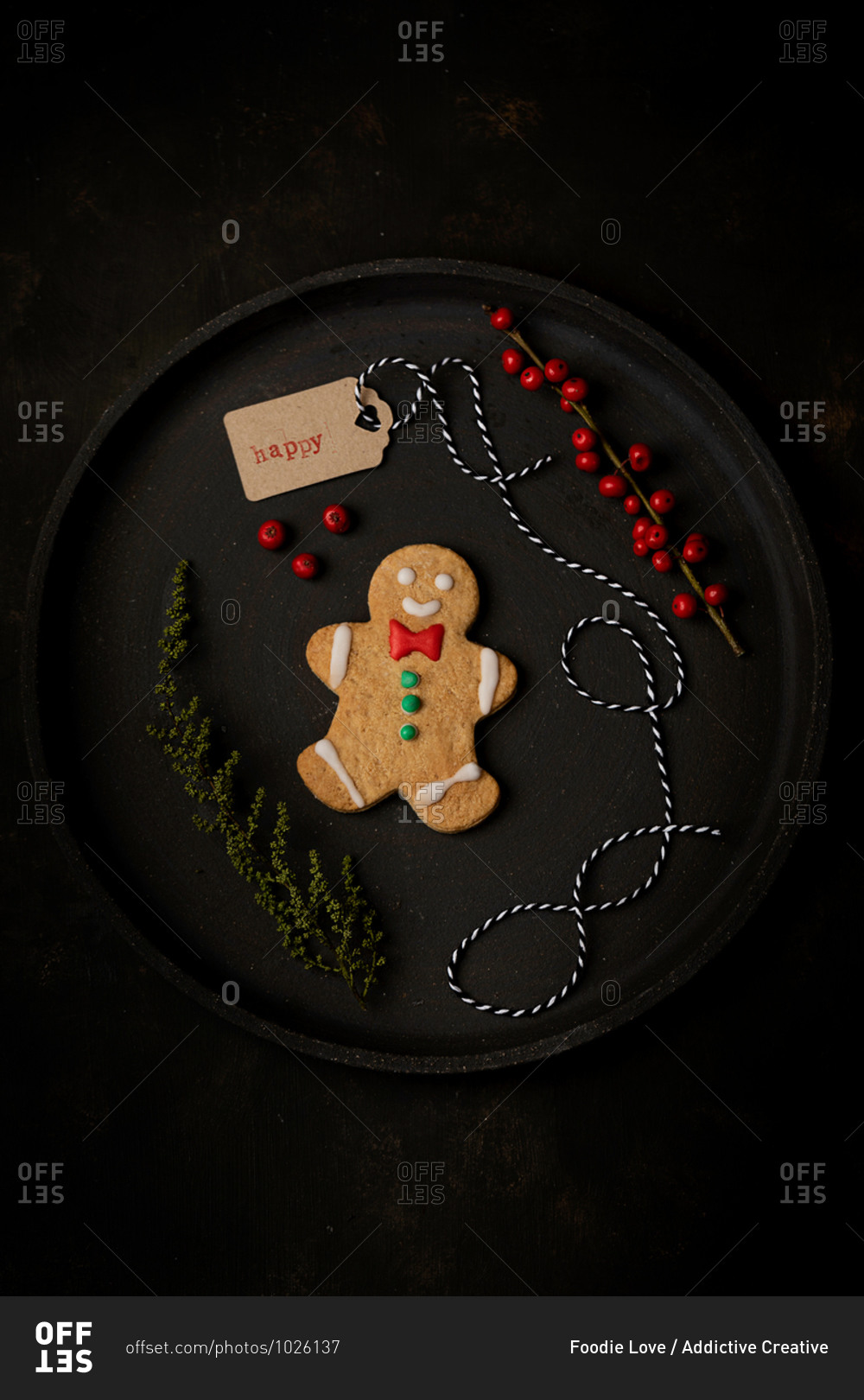 Top view of homemade Christmas gingerbread cookie placed on tray with holiday decorations