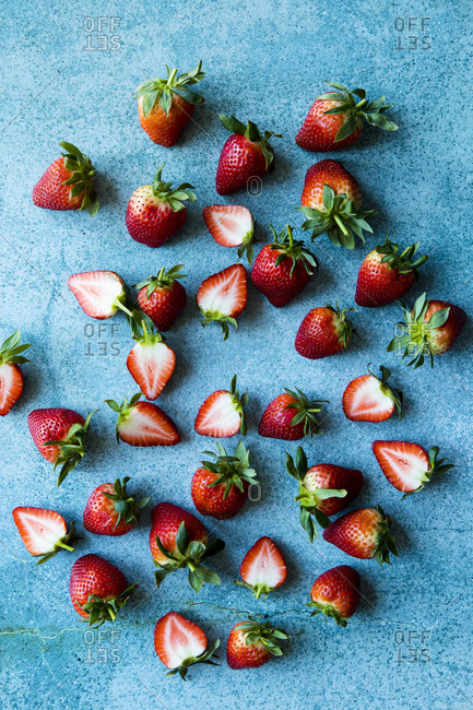 Overhead view of fresh strawberries on a blue table