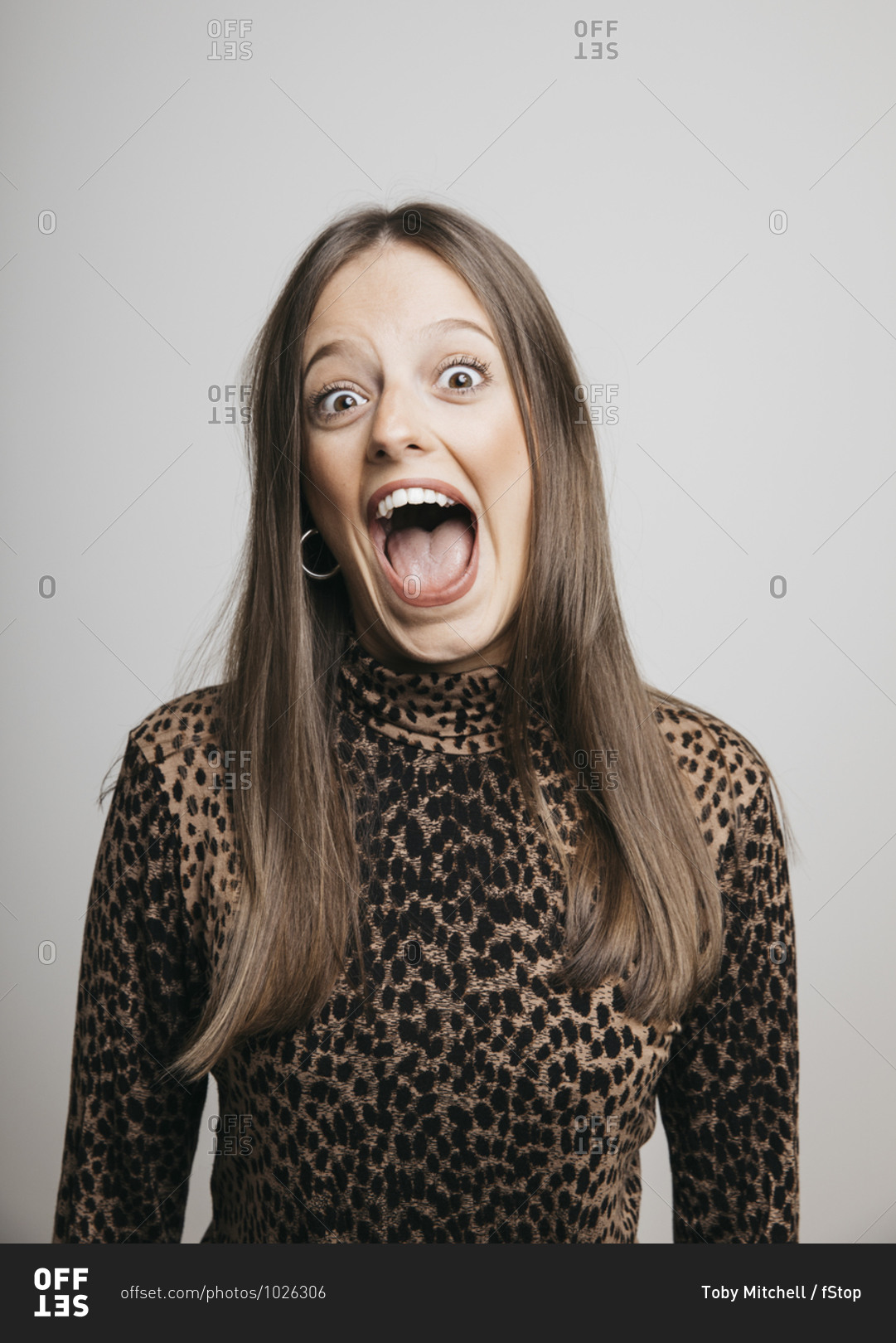 Portrait of excited young woman with mouth open