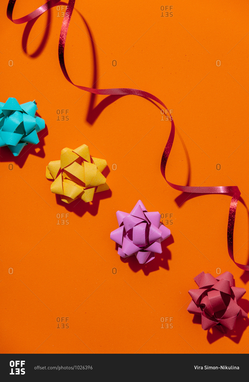 Overhead view of holiday bows on orange background