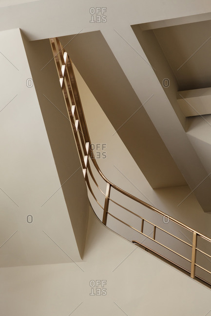 Gold railing inside of a modern building