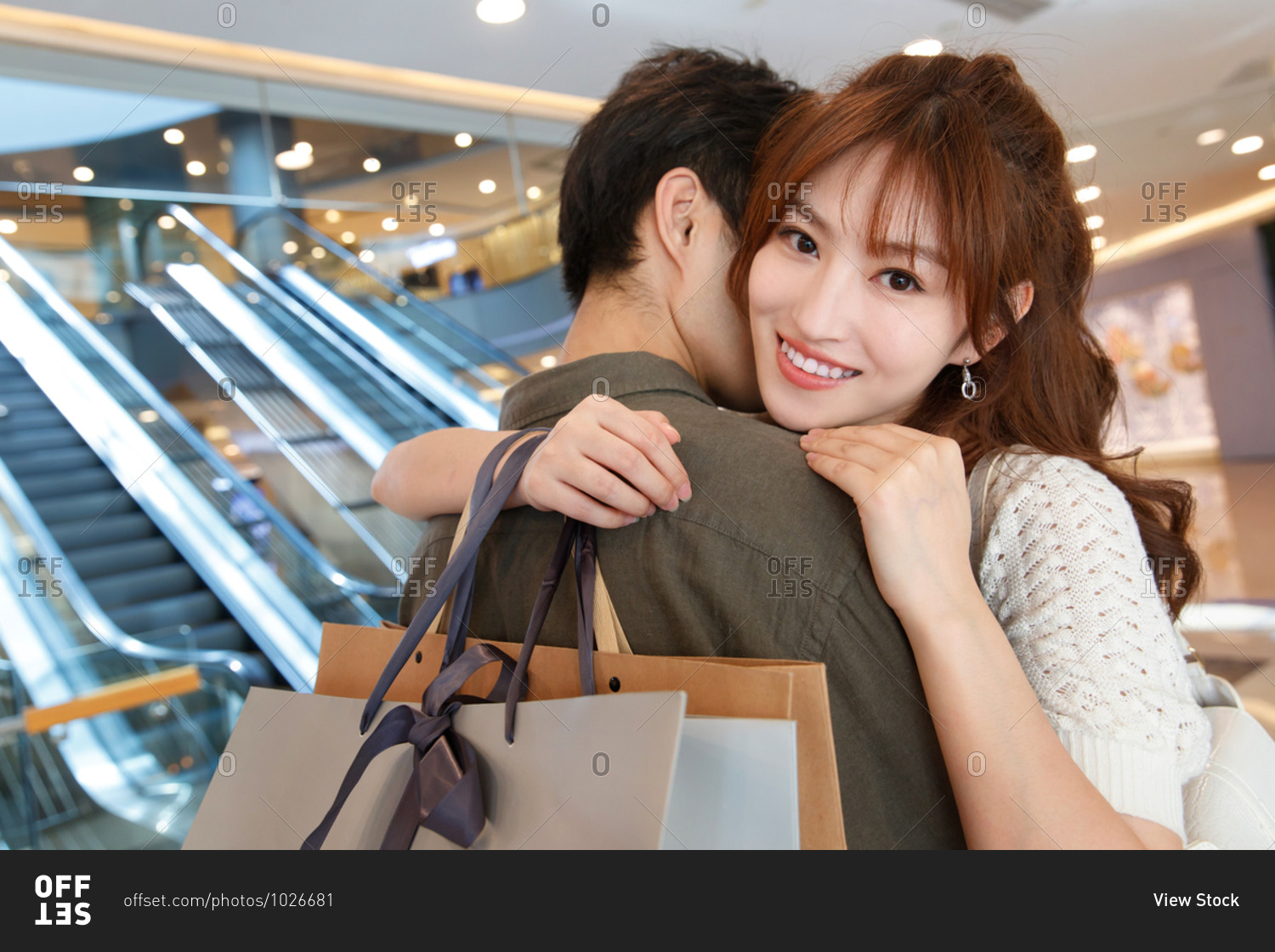 Young couple embracing after shopping together