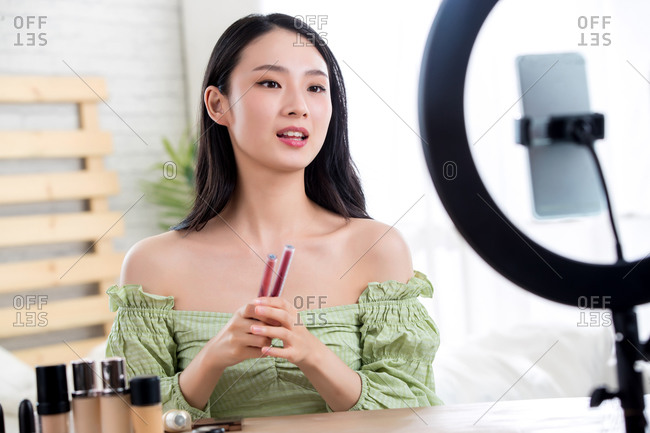 Young women livestreaming makeup tutorial