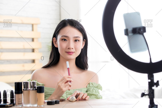 Young women livestreaming makeup tutorial