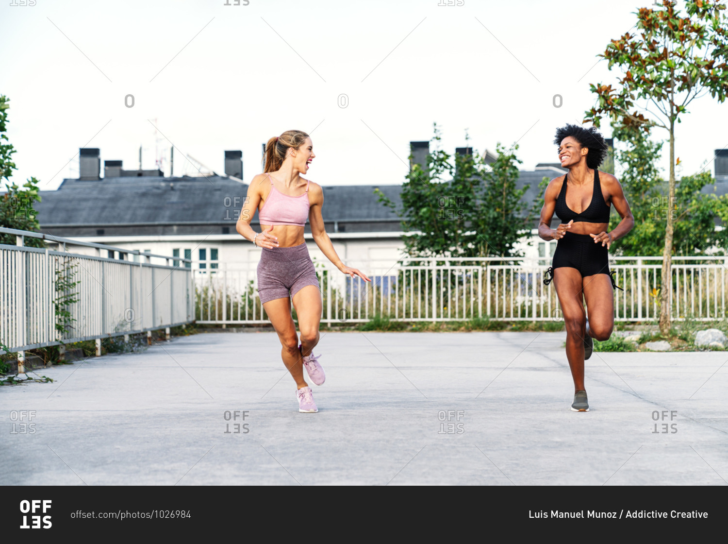Sportive multiethnic females in activewear competing with each other while running fast together during training