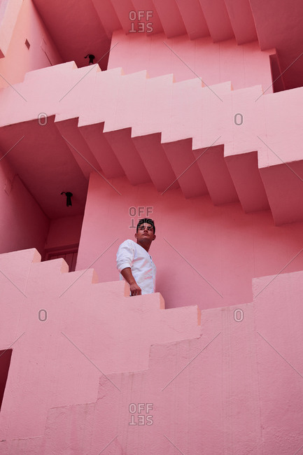 Calp, Valencian Community, Spain - August 6, 2020: Young Latin man in the "Muralla Roja" in Calpe, Spain