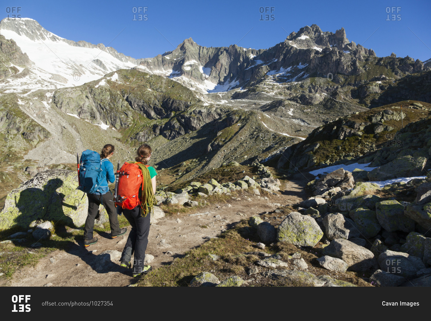Climbers hike trail above Furka Pass, Uri, Switzerland