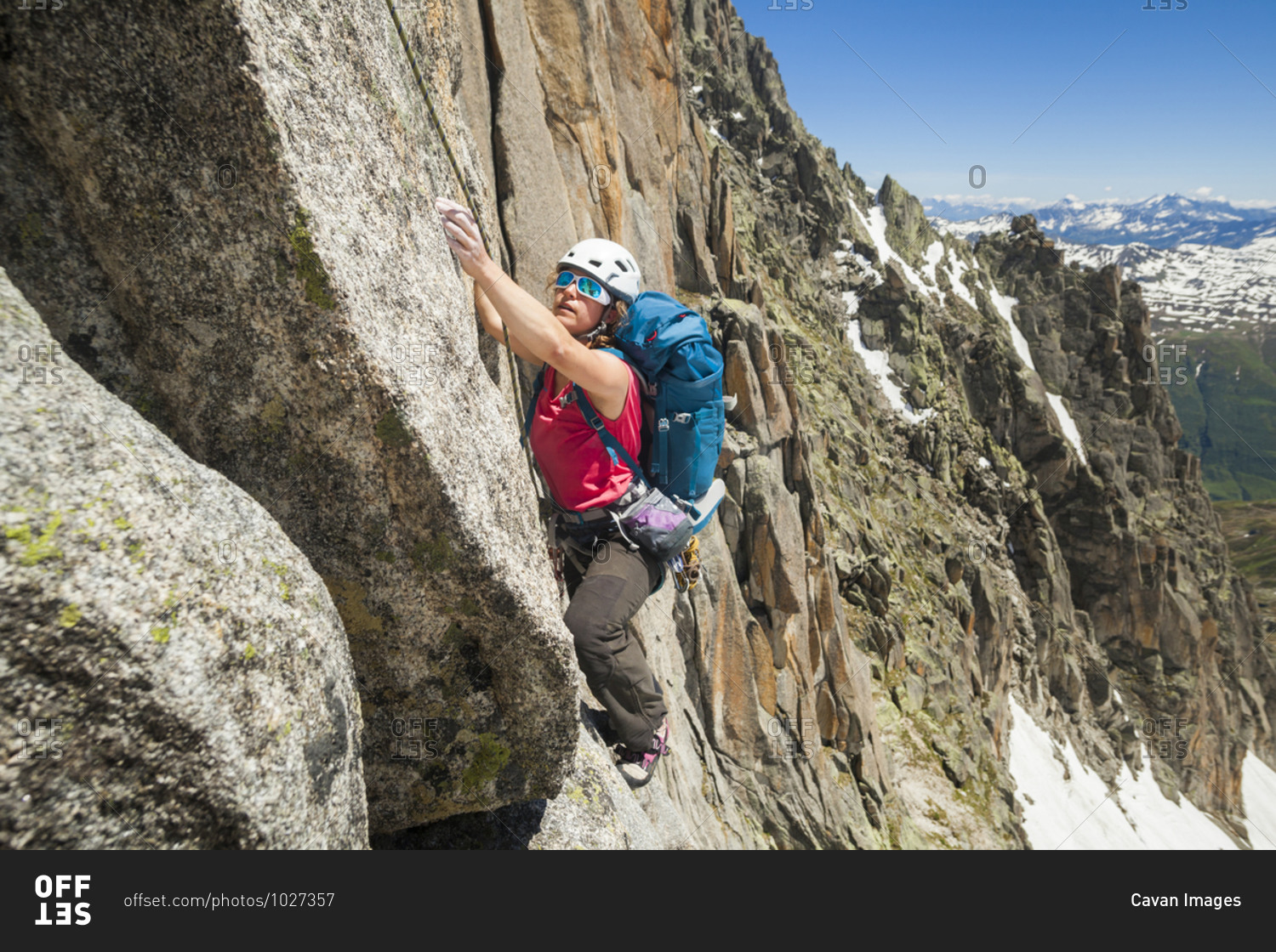 Woman rock climbs Via Amici on Lochberg, Furka Pass, Uri, Switzerland