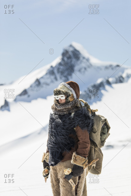 First Nations mountaineer exploring high altitudes, fur clothing.