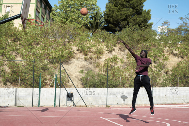 Young black man shooting basketball