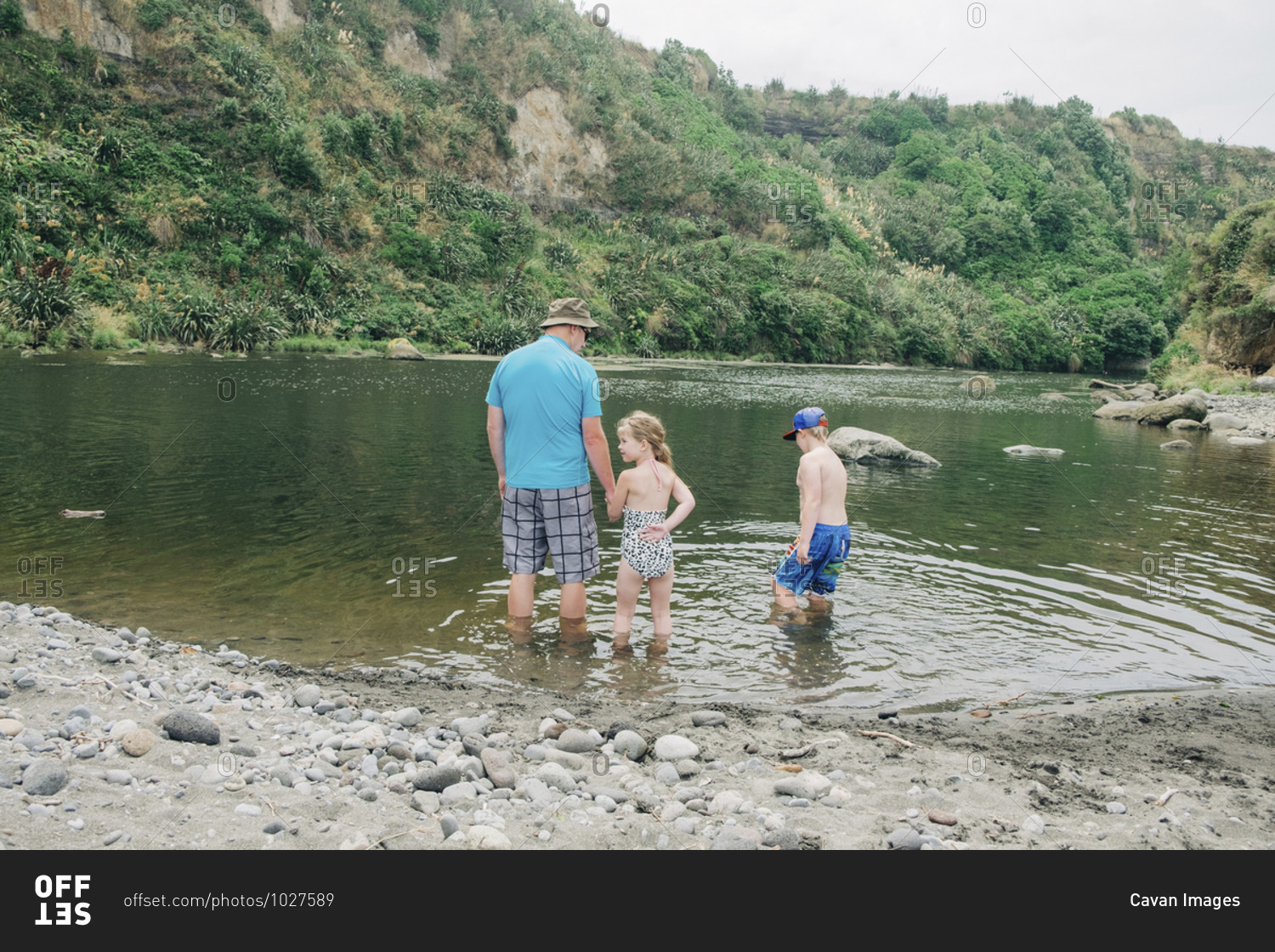 Family playing in the water at a scenic river spot