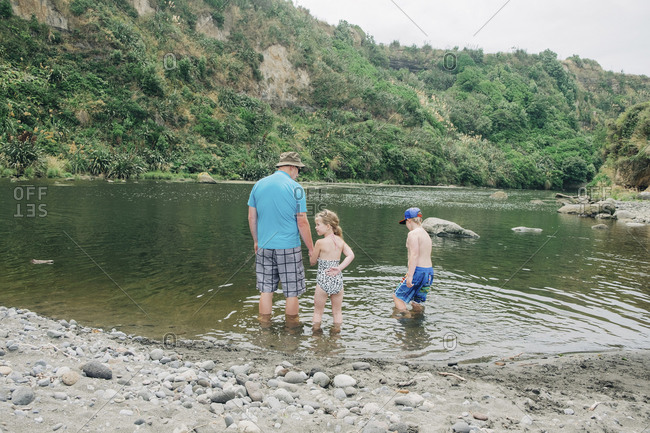 Family playing in the water at a scenic river spot