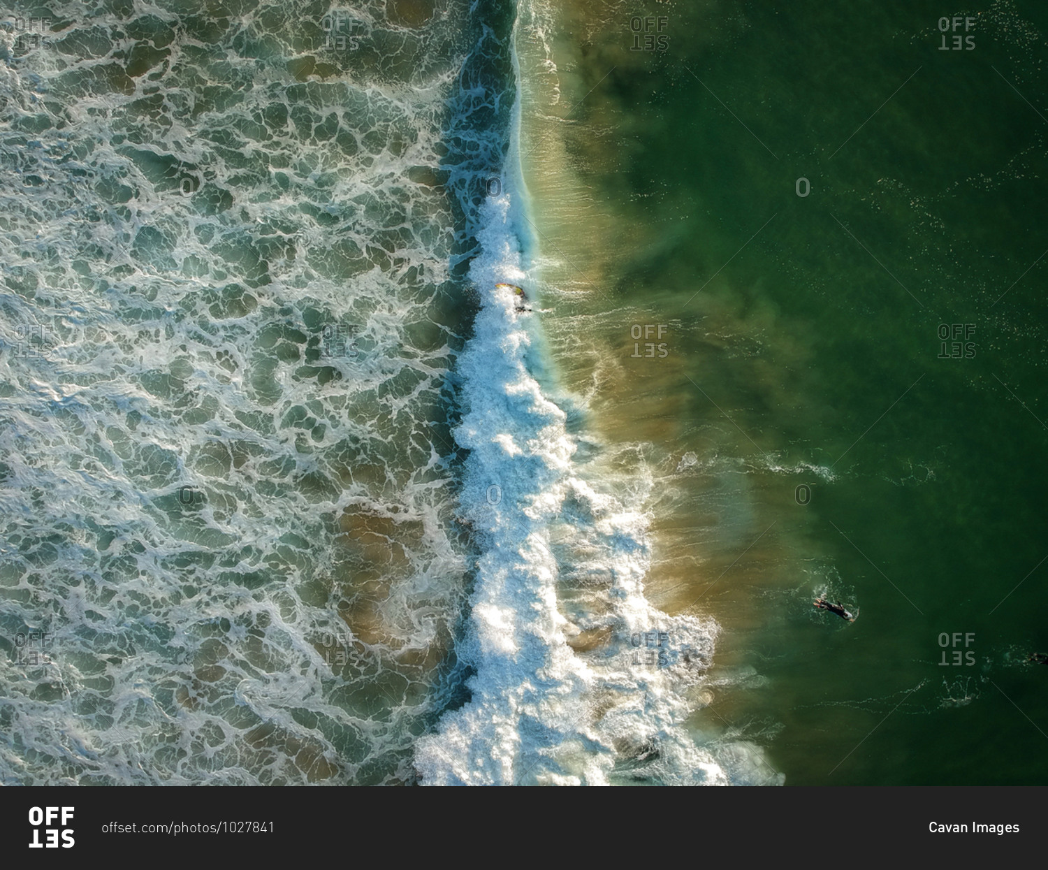 Aerial view of surfers and big wave in the ocean. Top view