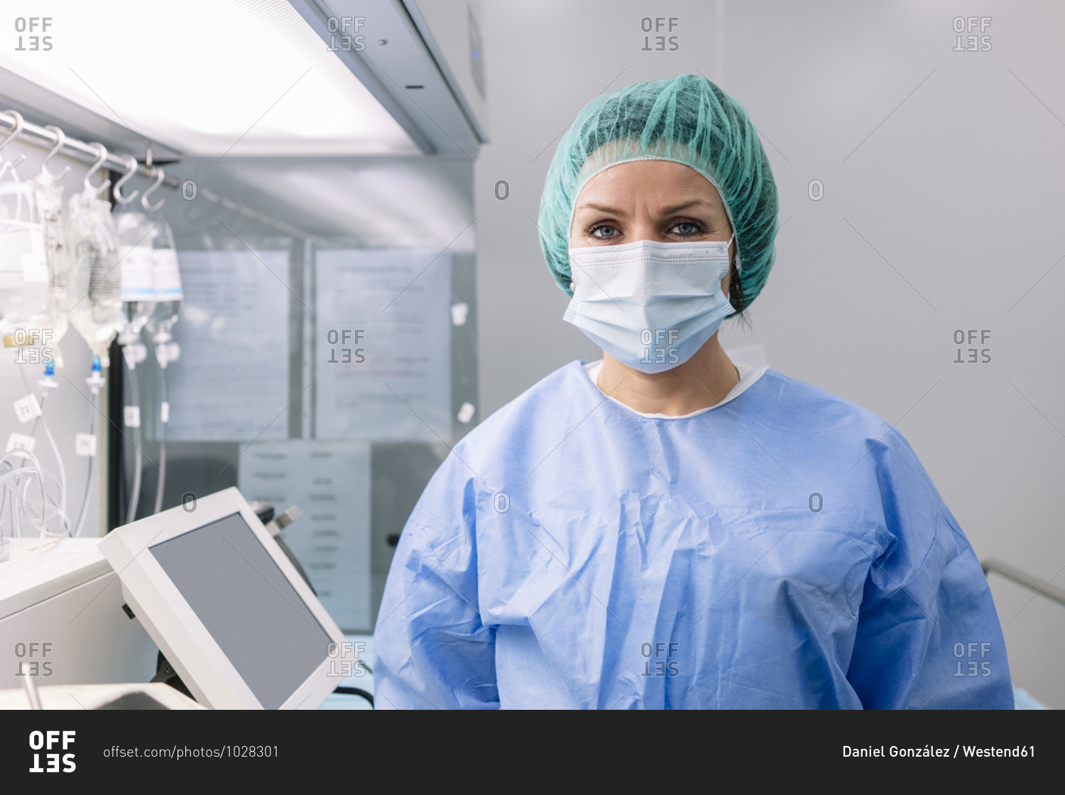 Female pharmacist wearing medical scrubs standing in laboratory