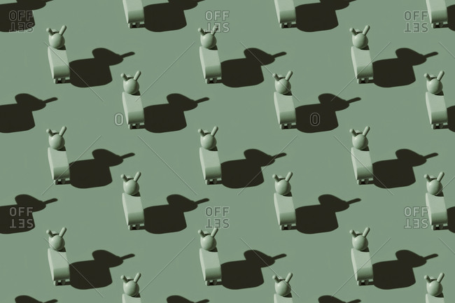 Pattern of small green donkey figurines against pastel green background