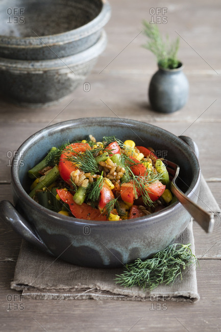 Bowl of ready-to-eat stir-fried vegetables with rye and dill