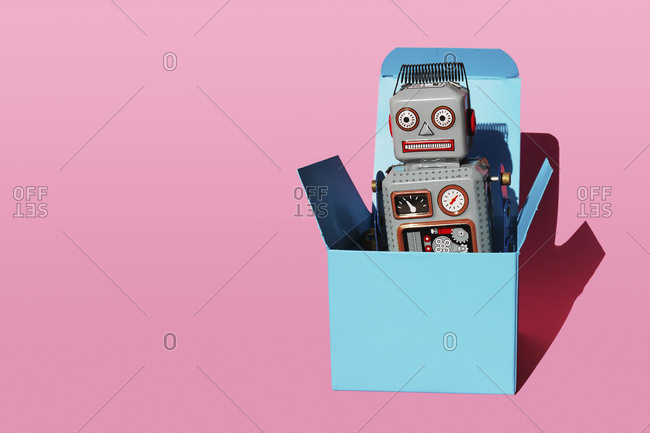 Studio shot of vintage robot toy in turquoise gift box