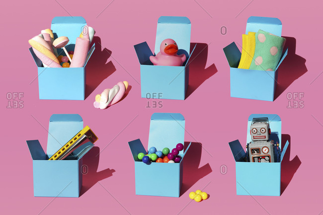 Pattern of boxes with various gifts consisting of harmonica- plastic spheres- vintage robot toy- sweets- rubber duck and pair of socks