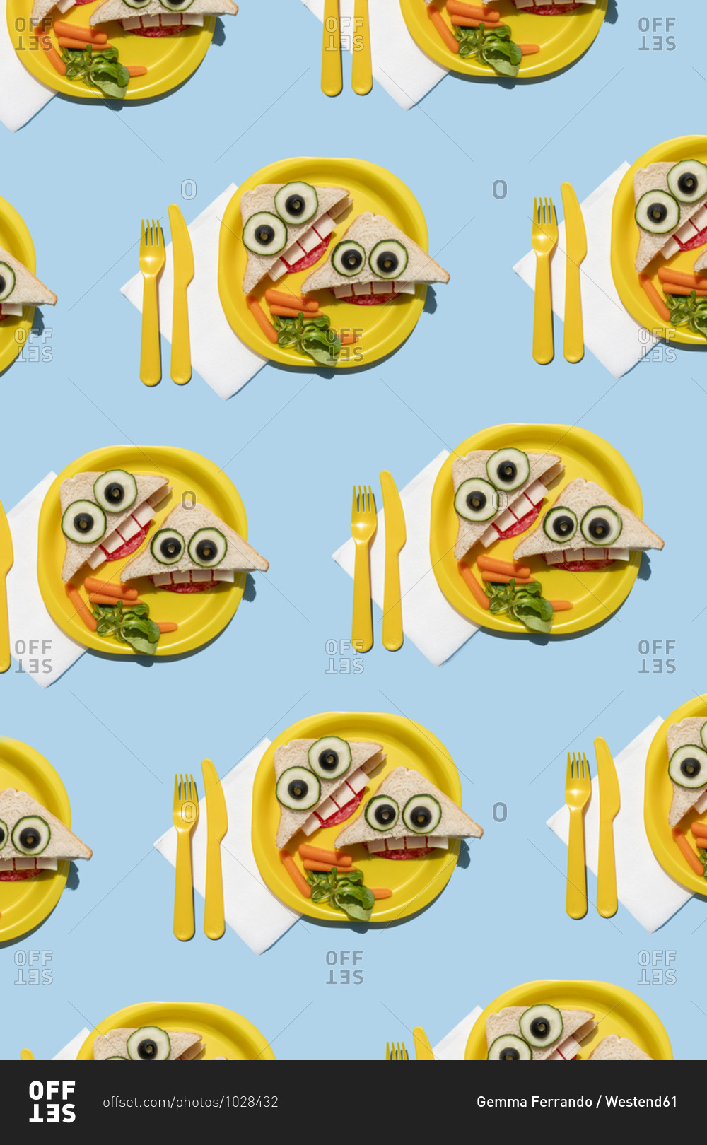 Pattern of plastic plates with funny looking sandwiches with anthropomorphic faces
