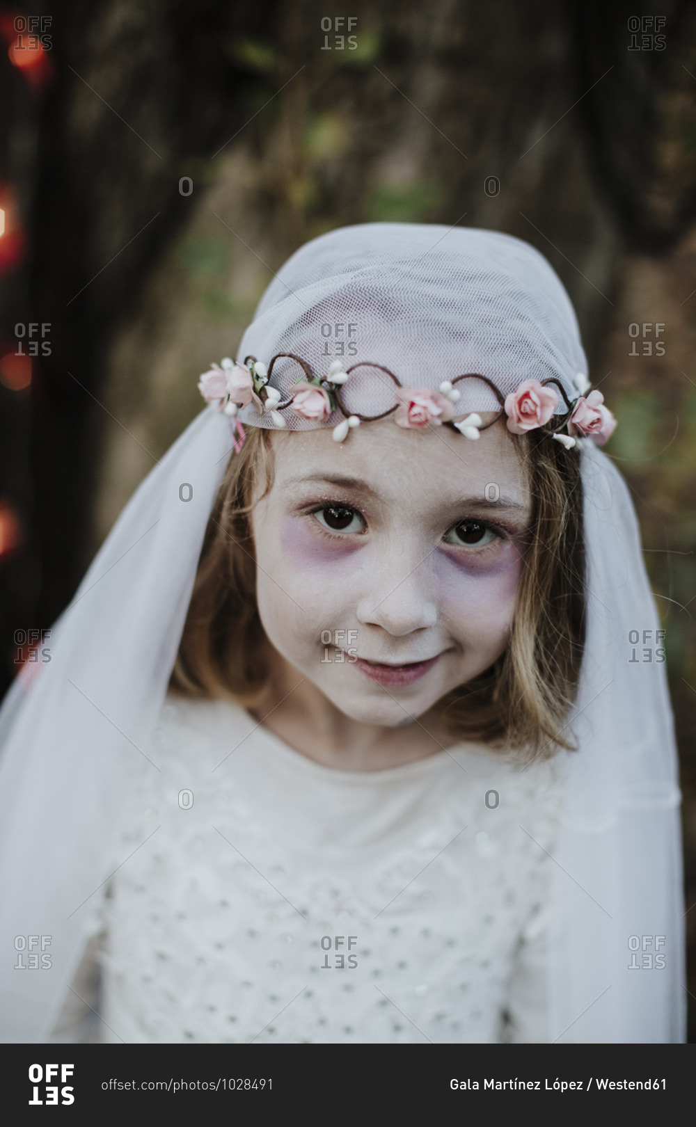 Cute girl wearing costume of corpse bride while standing in forest