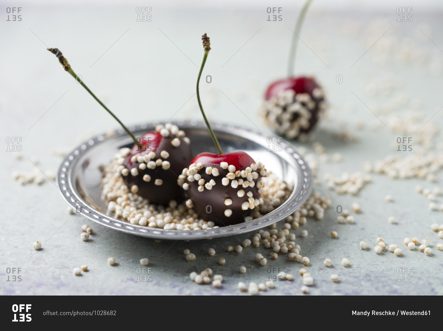 Close-up of chocolate covered cherries and quinoa in plate on table