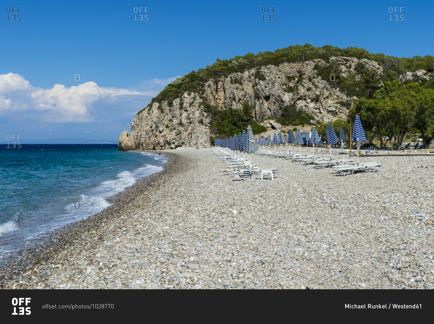 Greece- North Aegean- Rows of beach umbrellas and empty deck chairs on Tsambou beach in summer