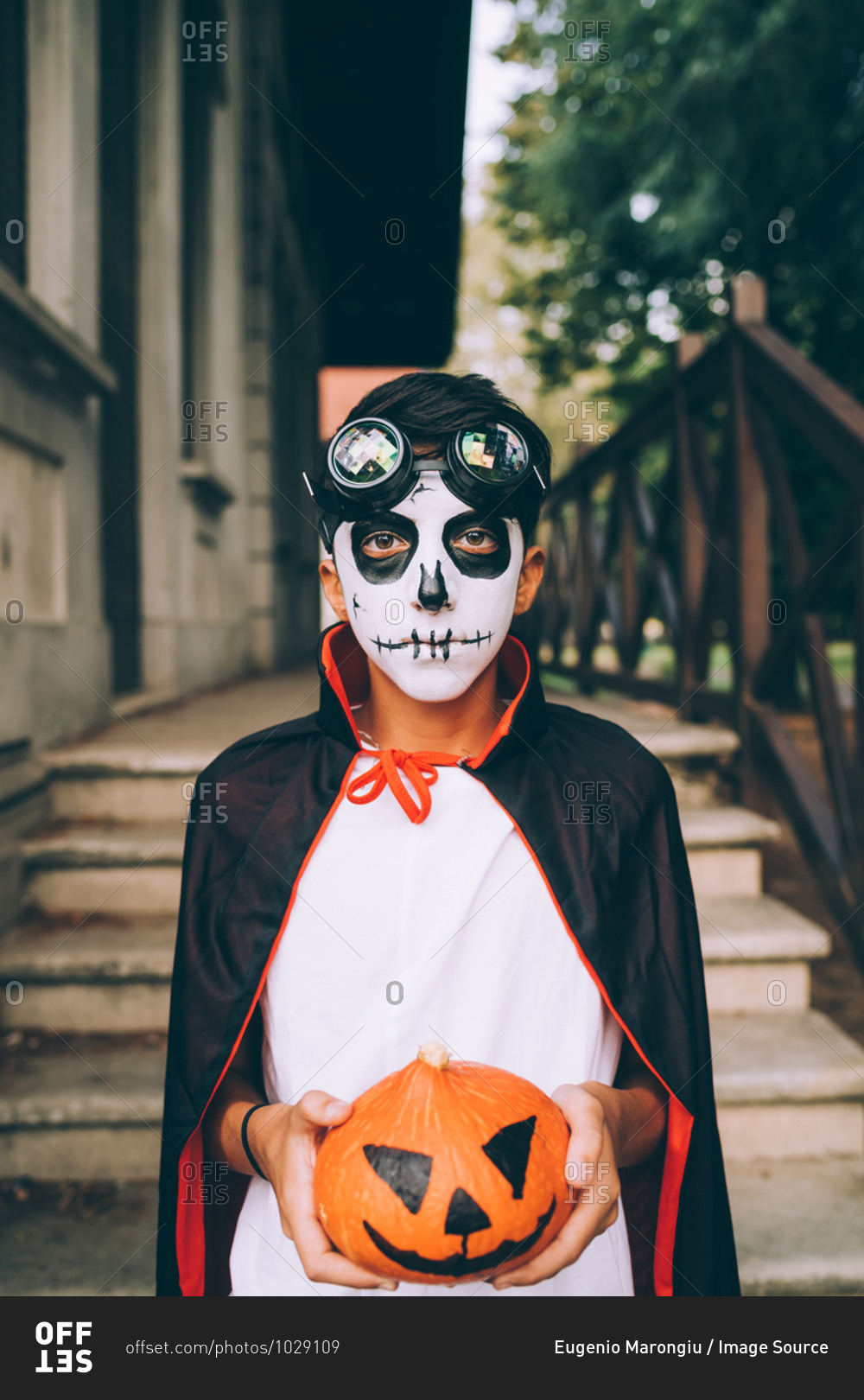 Boy in in Halloween costume with Jack-O-Lantern