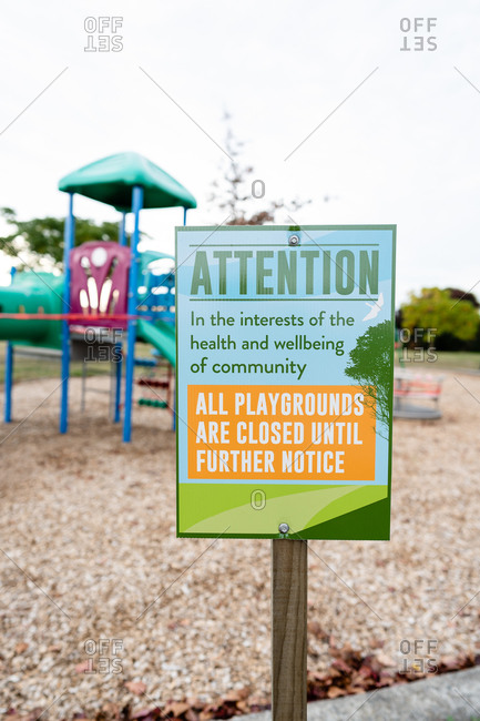 Sign stating all playgrounds are closed at a neighborhood park in Hawke's Bay, New Zealand