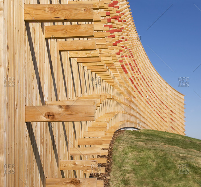 Estonia - September 22, 2020: Modern university buildings, wooden beams projecting from a curved wood cladding wall, on a curved ground surface