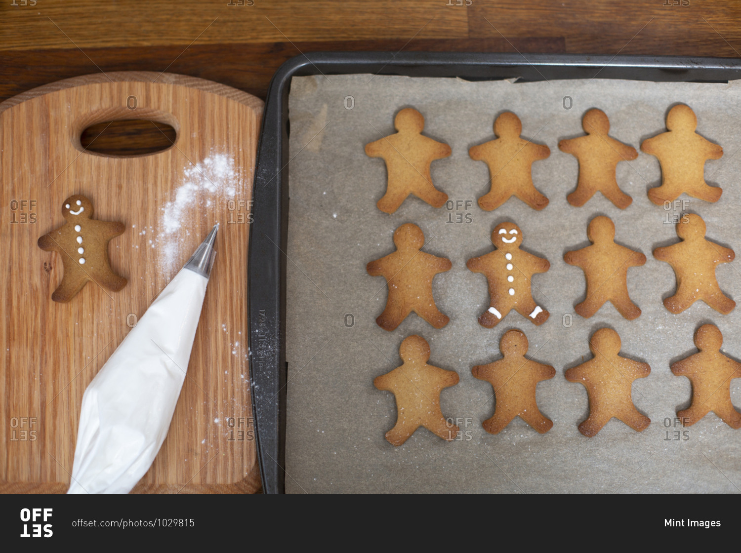 High angle close up of Gingerbread Men on a baking tray.