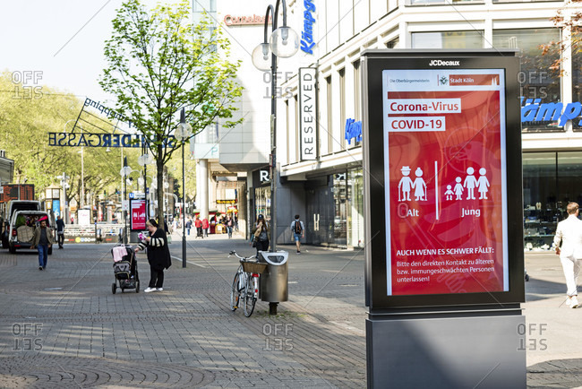 April 17, 2020: Advertising poster with recommended behavior for young and old in public space, on schildergasse in cologne city center.