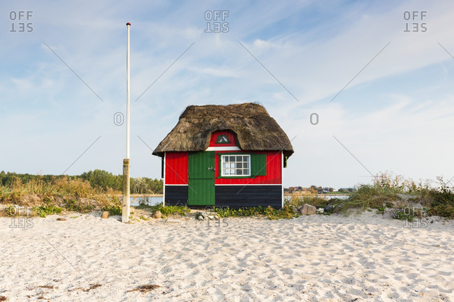 Thatched roof beach hut at a grass covered sand dune by the baltic sea, aero island