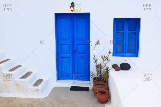 Typical blue painted door and window of a white washed santorin house