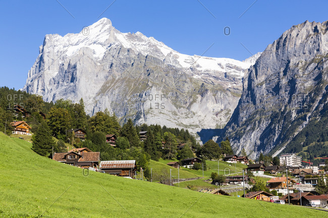 Chalets in front of mount wetterhorn, bernese alps, unesco world heritage site
