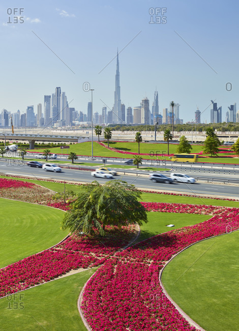 January 16, 2020: Skyline, green meadows, palm trees, flowers, dubai, united arab emirates