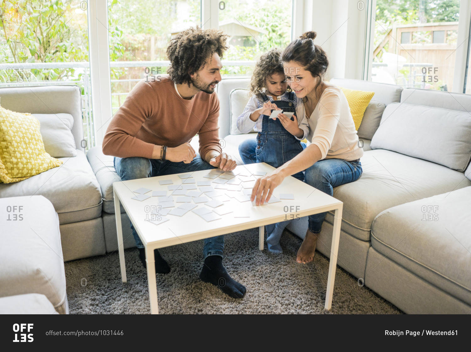 Family sitting on couch - playing memory game